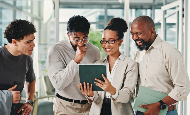 Diverse business group looking at tablet.